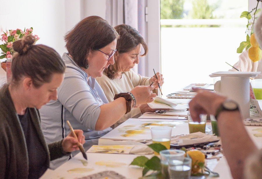 Retreat guests painting lemons together