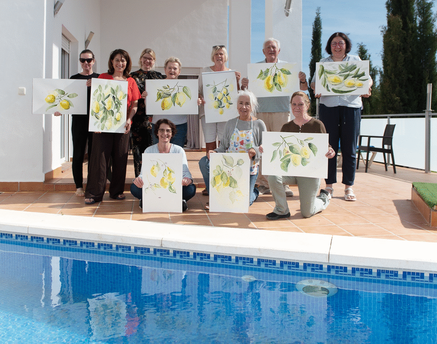 Retreat guests beside the pool holding their lemon paintings